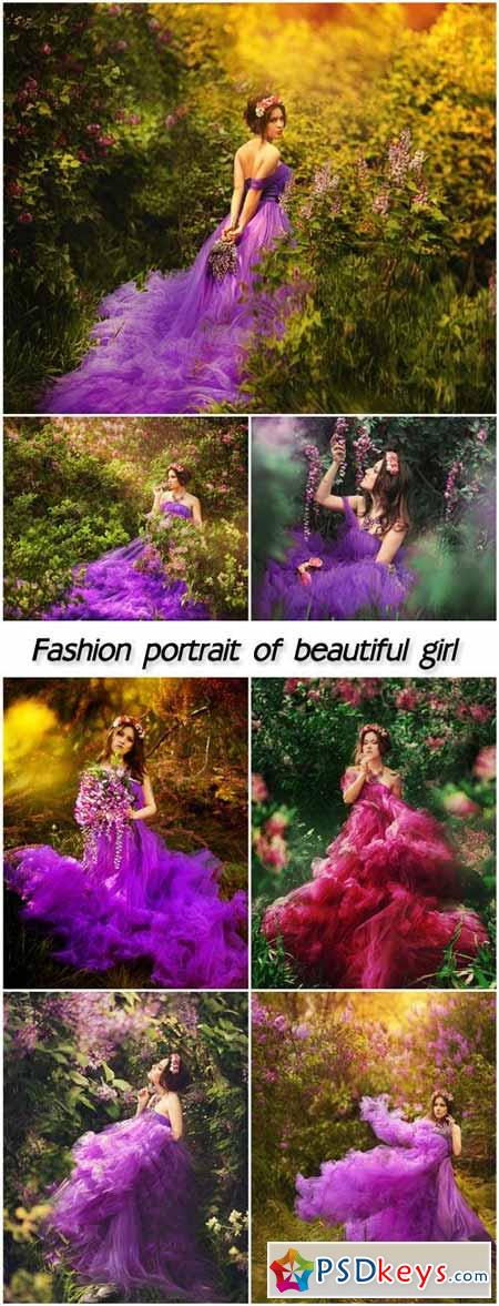 Fashion portrait of young beautiful pretty girl posing against lilac bushes in bloom