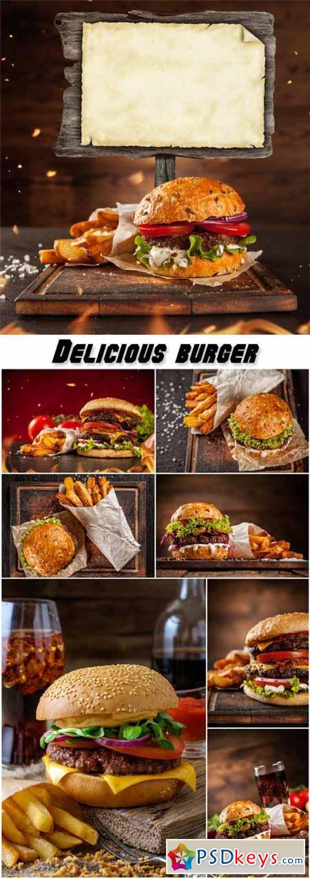 Delicious burger with chips and soda on wooden table