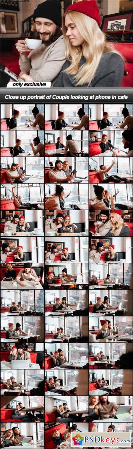 Close up portrait of Couple looking at phone in cafe - 39 JPG
