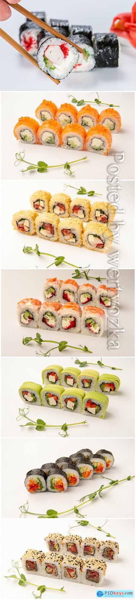 Sets of delicious fresh sushi on a white background