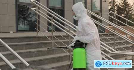 Worker in a Protective Suit Disinfects Surfaces From Coronavirus Antibacterial Sanitary Measures on 26235927