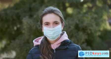Attractive Girl Takes on Medical Mask During Coronavirus COVID-19 Epidemic 26181719