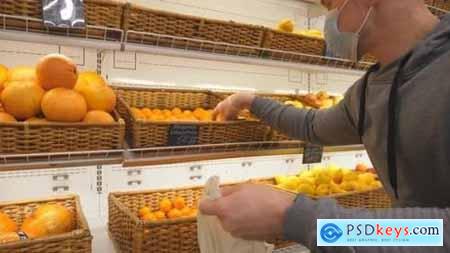 Man with Medical Face Mask Selects Mandarins in Store Guy Choose Fruits in Supermarket Purchase 26163408