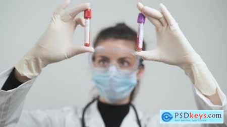 Doctor Comparing Blood Samples From Corona Positive Patients at Laboratory 26218962