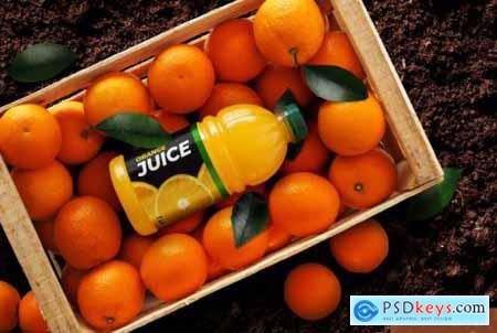 Orange juice bottle over oranges box