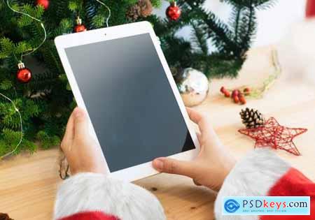 Santa Claus hands with a white tablet mockup