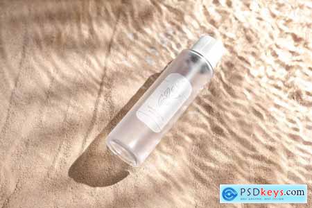 Serum Bottle on Sand and Water Wave Background 7FFZBVM