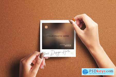 Hand Pinning Instant Photo on a Board